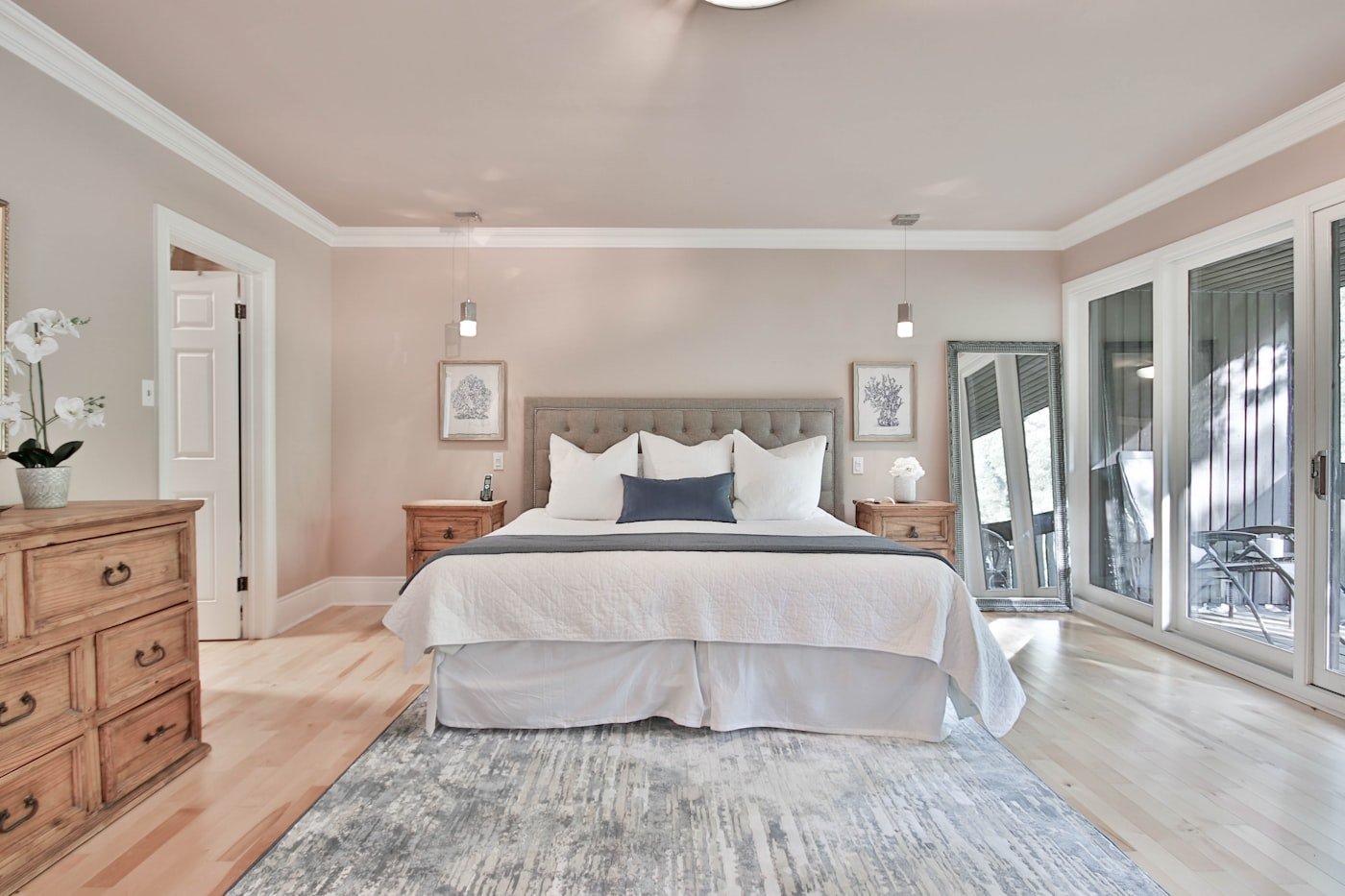 Bedroom with floor-length lined curtains hung high above a window