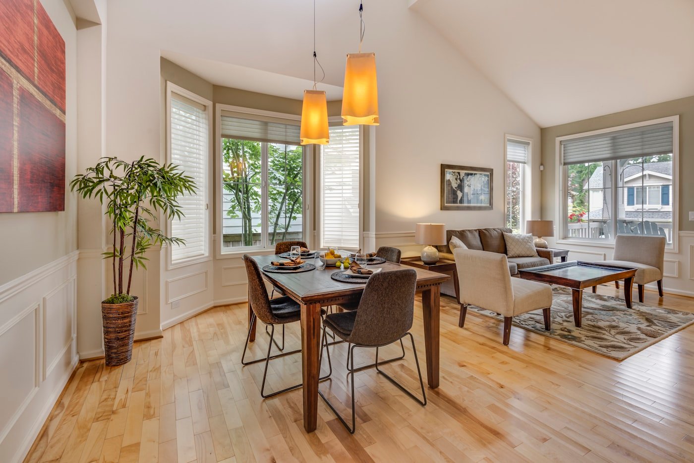 Dining table with a large pendant light hanging low above it