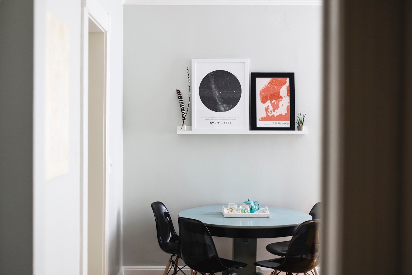 Dining room painted in a deep navy with warm lamp light