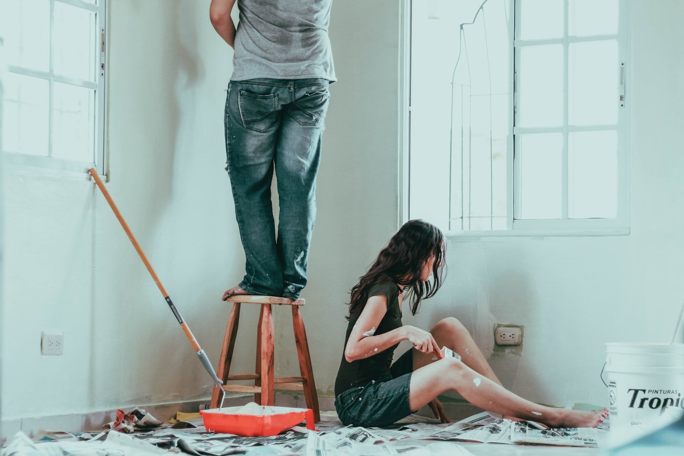 Angled brush cutting in paint along a ceiling line