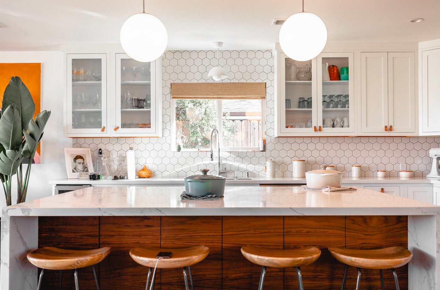 Kitchen with warm greige cabinets in a room with a small window