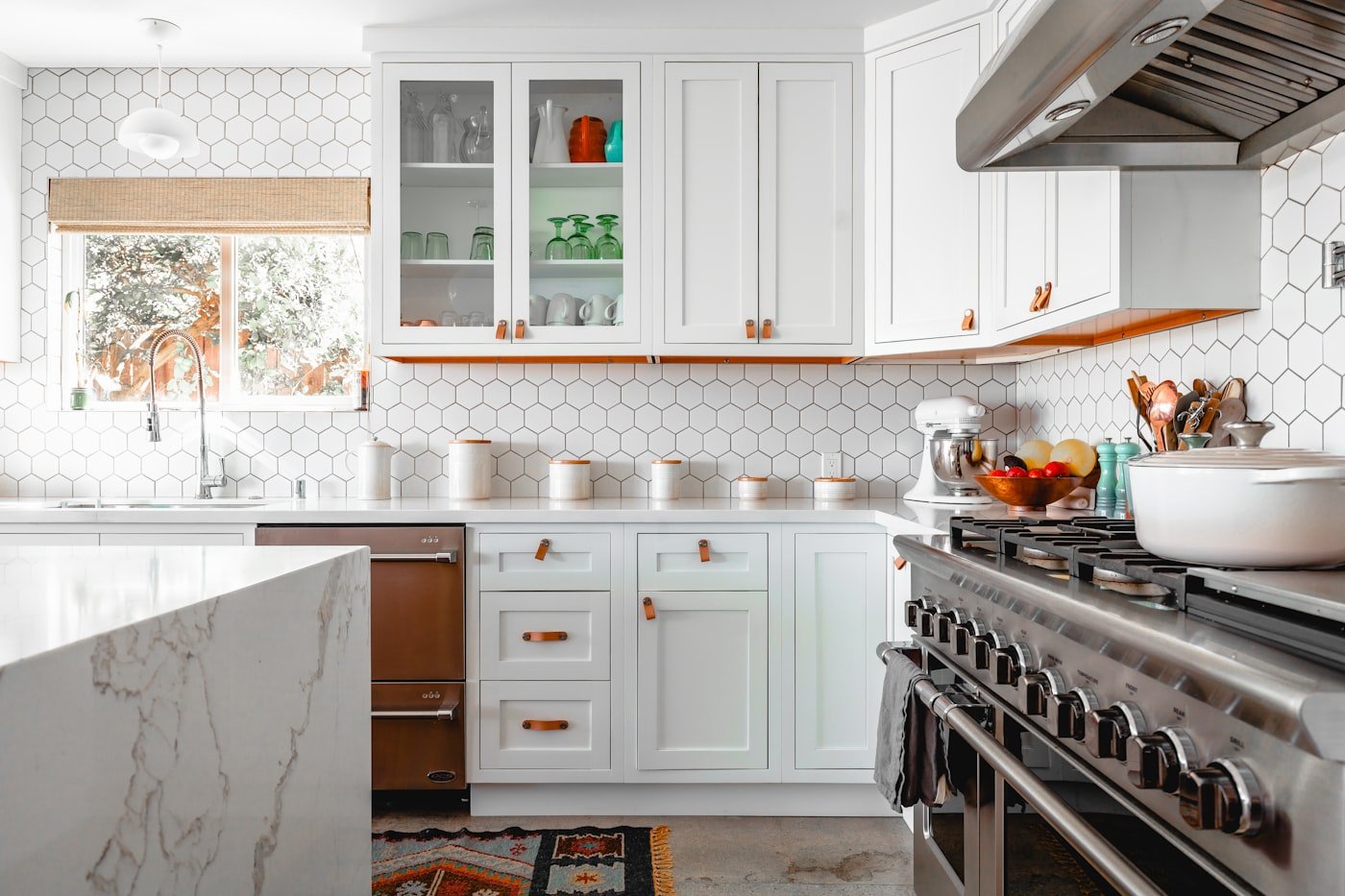 Bright kitchen with black lower cabinets, white walls and a large window