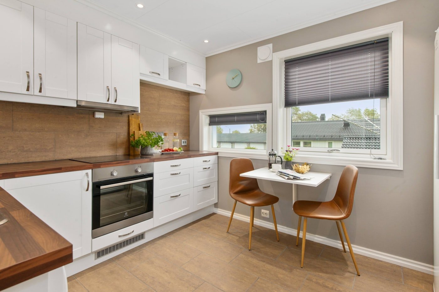Kitchen with pale blue grey cabinets and white subway tile