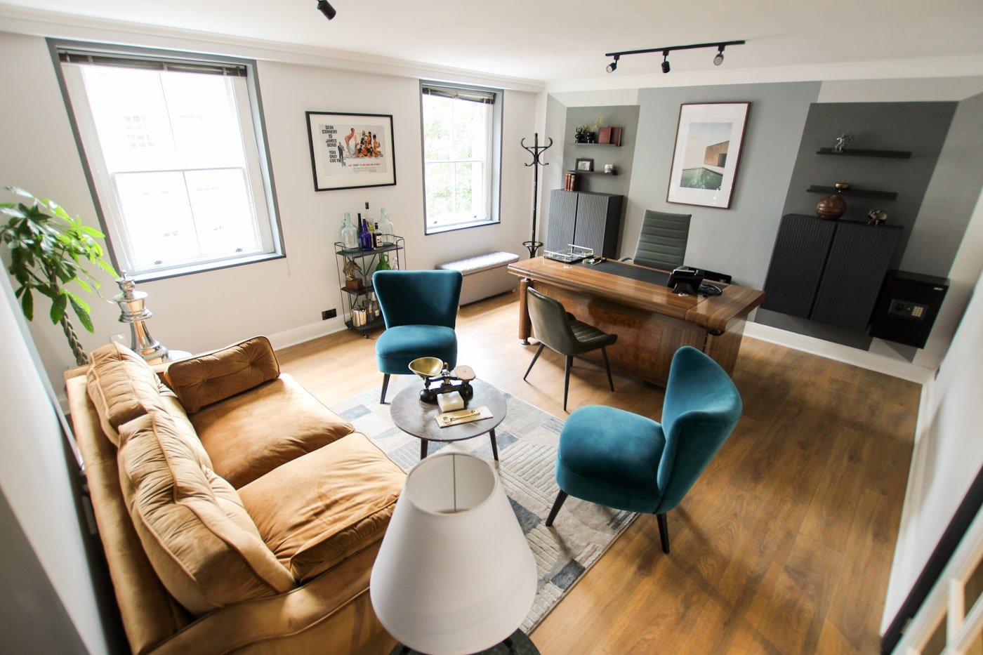 Wall-mounted fold-down desk in a hallway with a stool tucked under