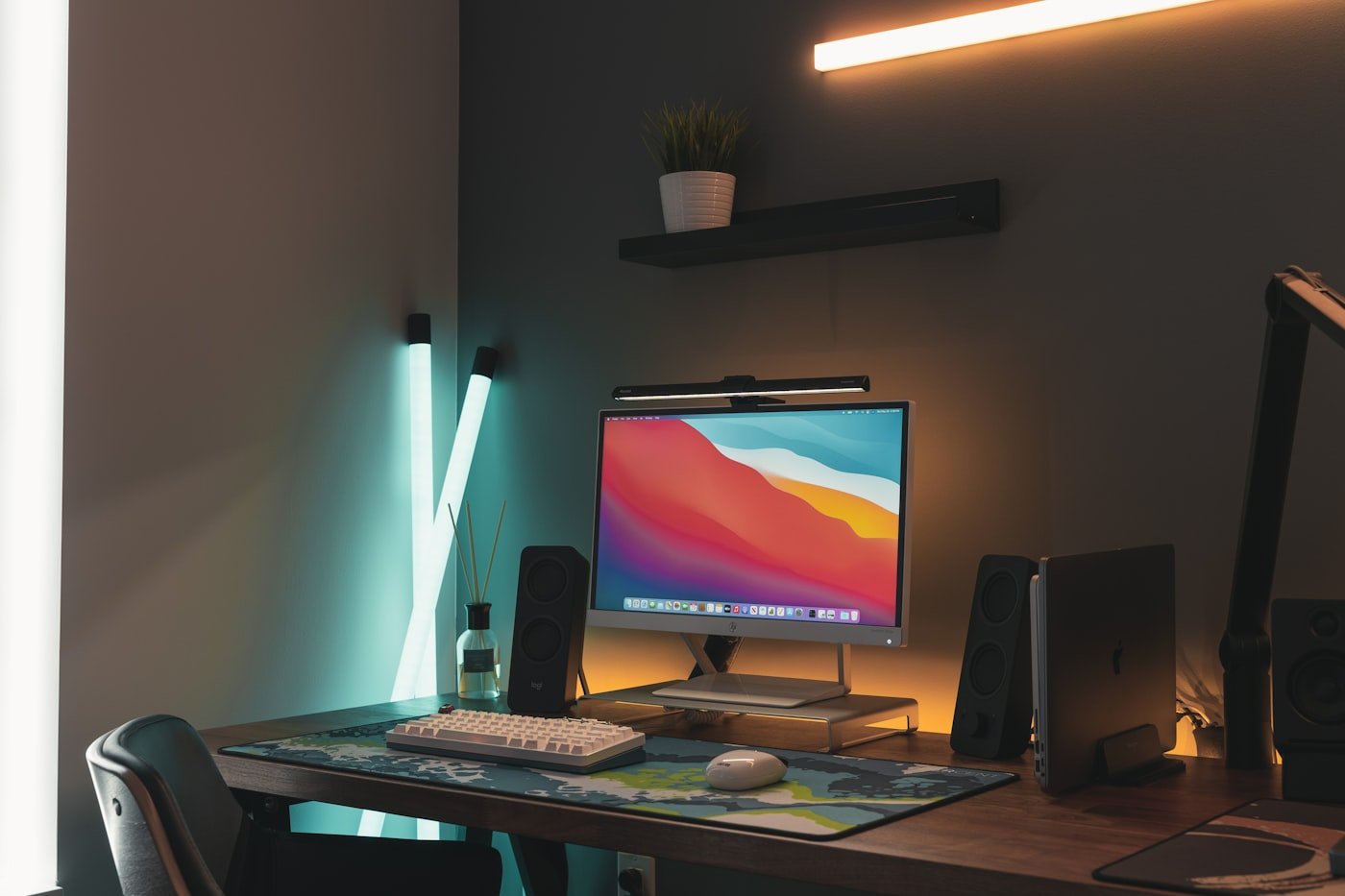 Desk with three floating shelves above it reaching to the ceiling