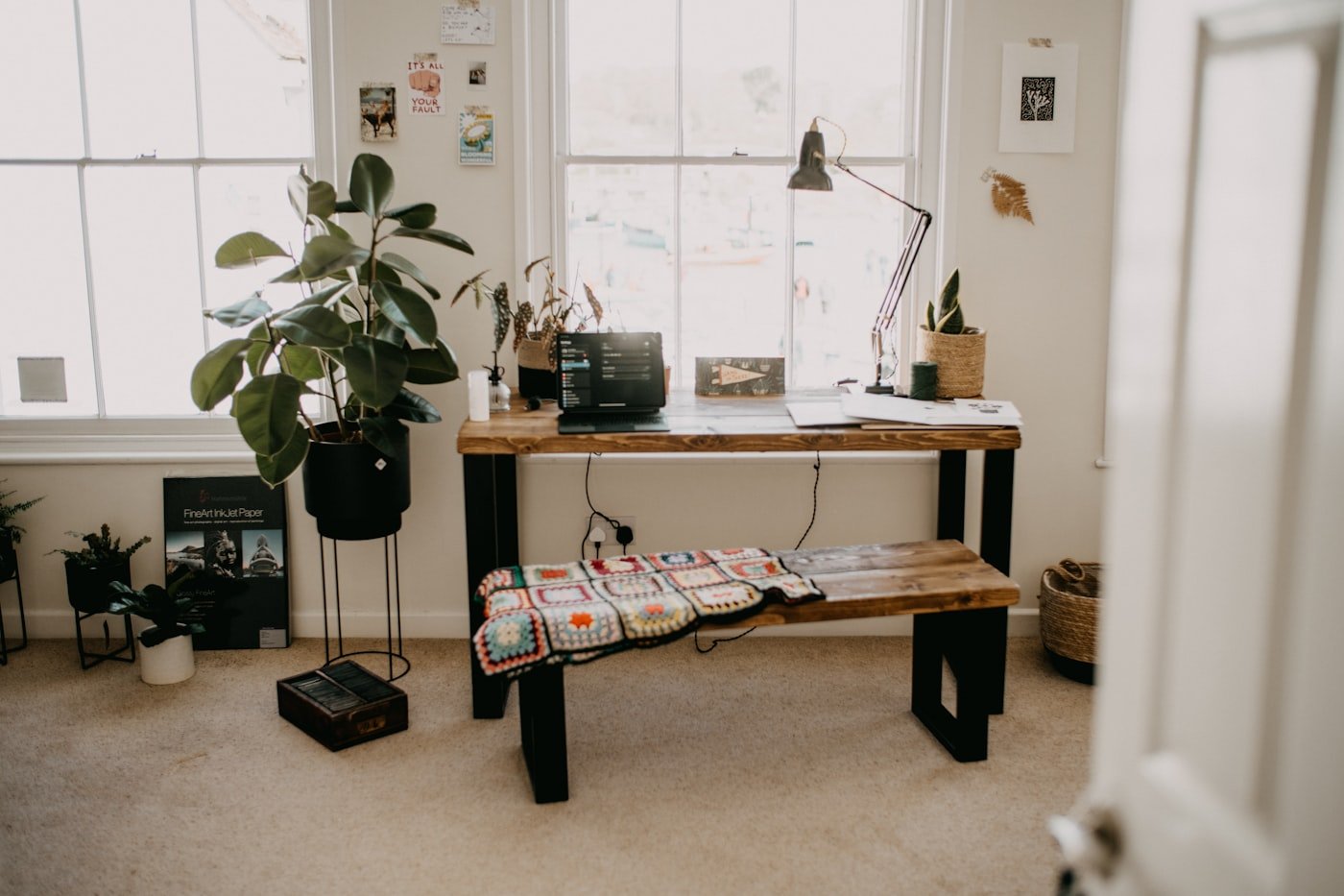 Open bookshelf used as a room divider separating a desk area from a living space