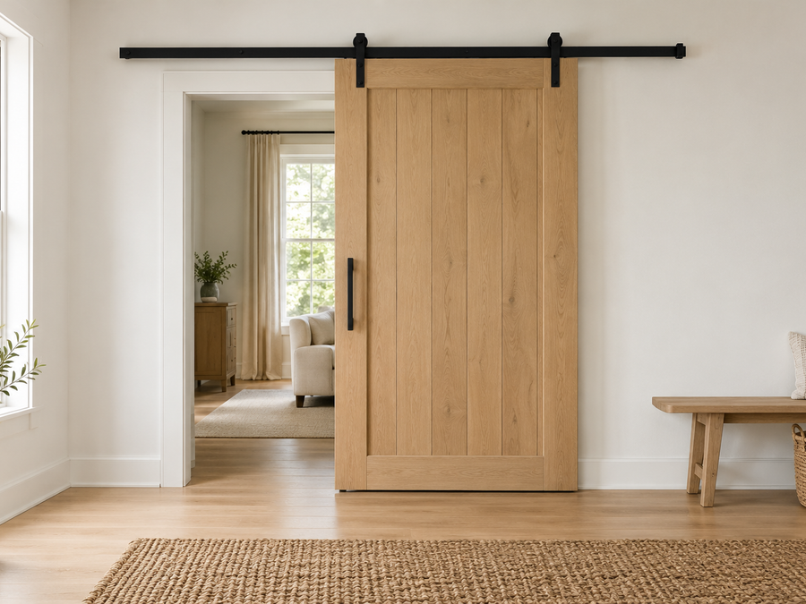 barn door size for opening example: a white oak sliding barn door on a black track, overlapping the doorway on both sides